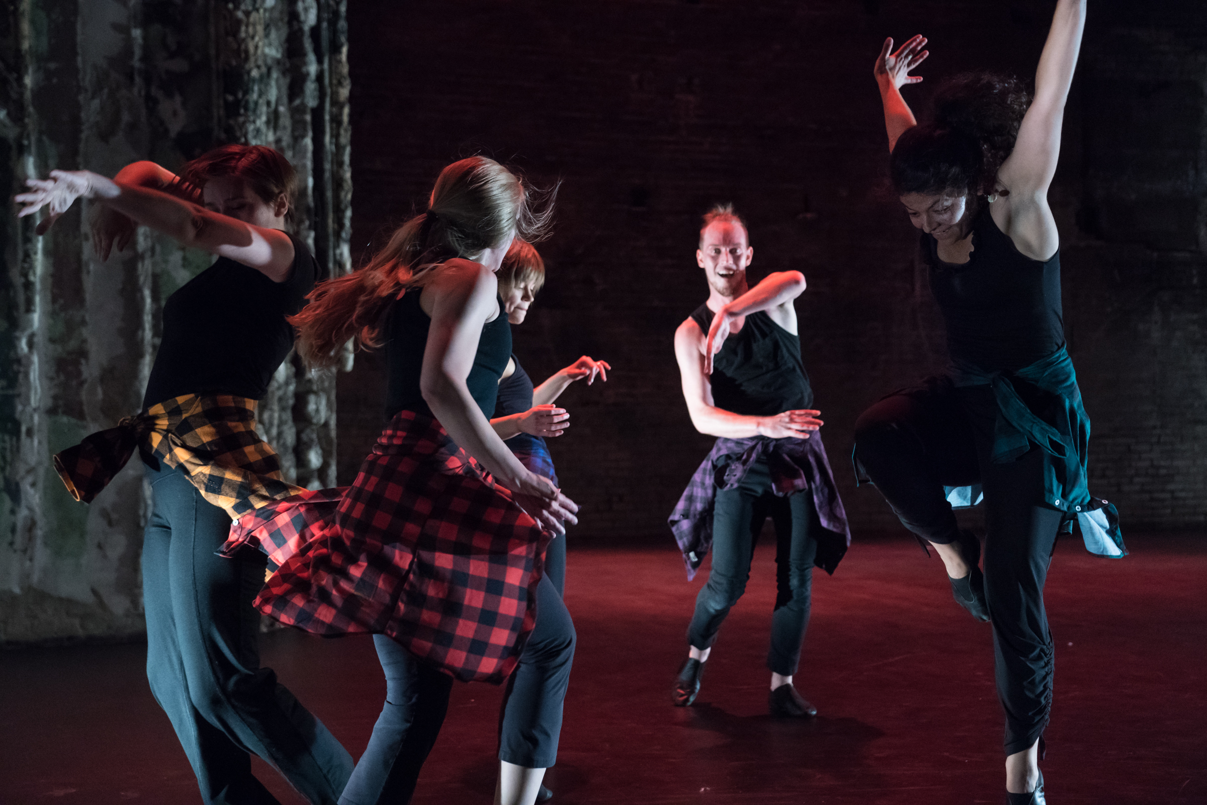 A group of dancers jumping and smiling