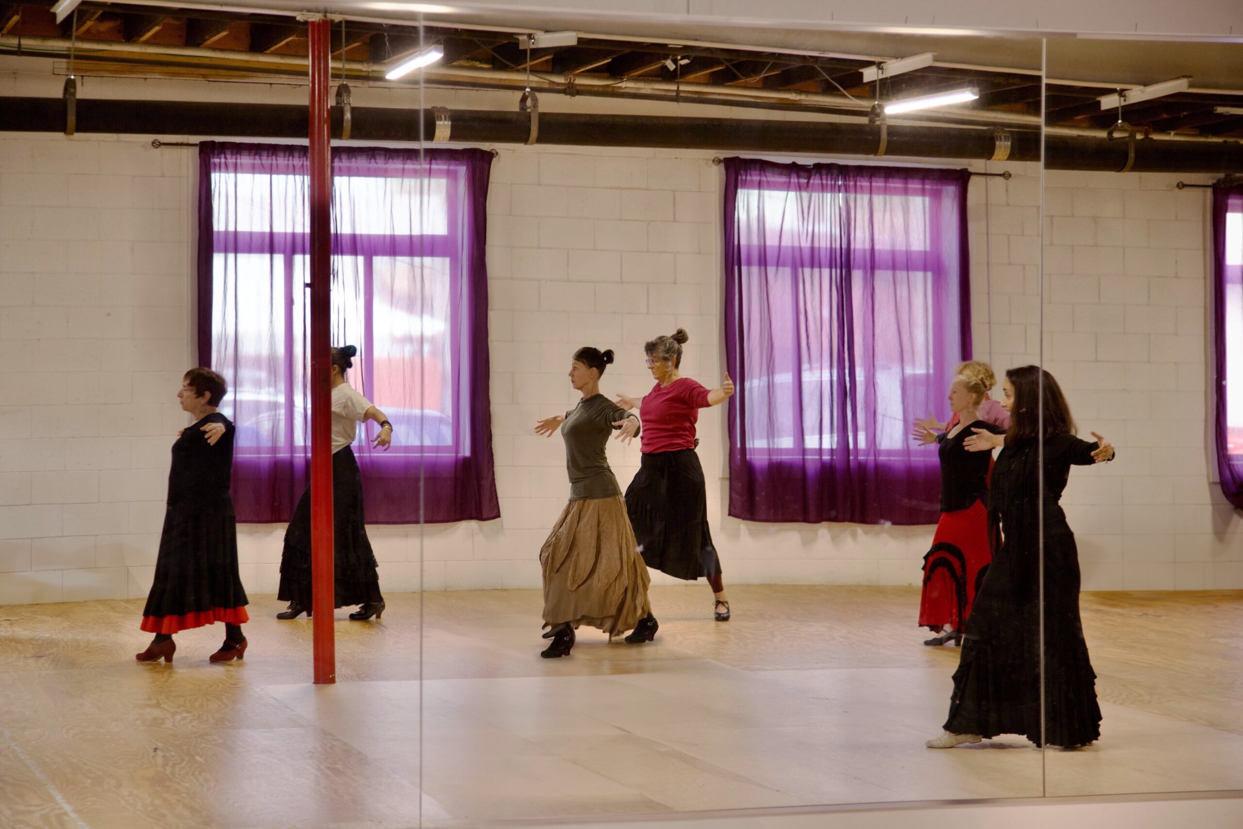 An image of the Zorongo dance studio, with several dancers practicing in the mirrors